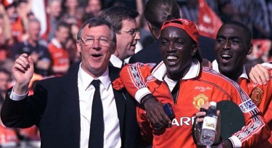 Manchester United's Dwight Yorke with manager Alex Ferguson after the Premier League game against Tottenham Hotspur. Old Trafford, Manchester, 16 May 1999.