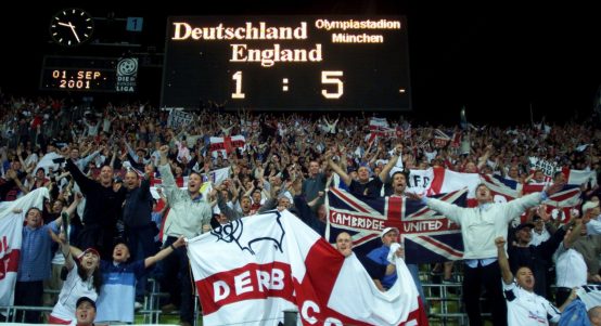 England football fans cheer and sing after a World Cup Qualifying match England against Germany in Munich Olympic Stadium September 1, 2001.