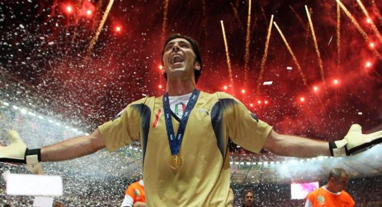 Gianluigi Buffon celebrates with his arms open and fireworks above his head after Italy had won the 2006 World Cup final against France in Berlin, July 2006.