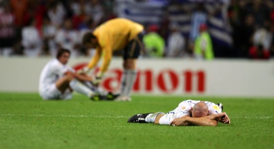 Czech Republic's Jan Koller lies dejected at the final whistle following defeat to Greece at Euro 2004