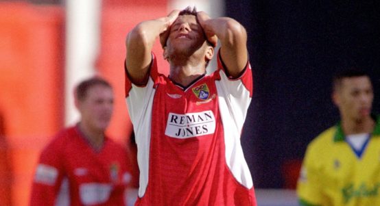 Morecambe's Julian Dowe holds his head in despair after missing a great chance