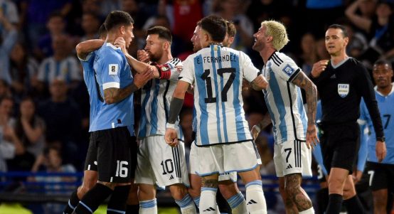 Argentina's Lionel Messi, second left, argues with Uruguay's Mathias Olivera, during a qualifying soccer match for the FIFA World Cup 2026 at La Bombonera stadium in Buenos Aires, Argentina, Thursday, Nov. 16, 2023.
