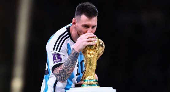 Lusail, Qatar. 18th Dec, 2022. Soccer, World Cup 2022 in Qatar, Argentina - France, Final, at Lusail Stadium, Argentina's Lionel Messi kisses the World Cup trophy as he receives the "Golden Ball Award"
