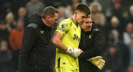 Newcastle United goalkeeper Nick Pope (centre) is helped off the pitch by medical staff after picking up an injury during the Premier League match at St. James' Park, Newcastle. Picture date: Saturday December 2, 2023.
