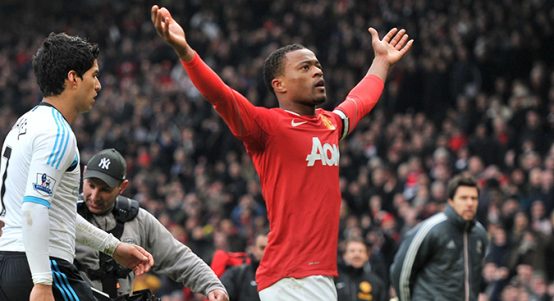 Patrice Evra celebrates in front of Liverpool's Luis Suarez at Old Trafford, Manchester. 11 February 2012.