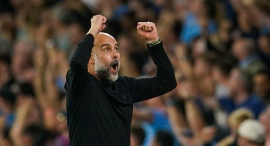 Manchester City's head coach Pep Guardiola celebrates after Manchester City's Julian Alvarez scoring his side's opening goal during the English Premier League soccer match between Manchester City and Newcastle at the Etihad stadium in Manchester, England, Saturday, Aug. 19, 2023.
