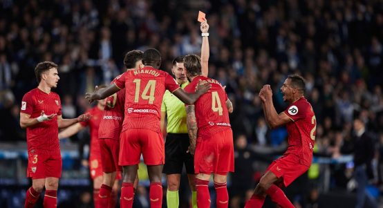 Miguel Angel Ortiz Arias shows a red card to Sergio Ramos of Sevilla FC during the LaLiga EA Sports match between Real Sociedad and Sevilla FC at Reale Arena on November 26, 2023, in San Sebastian, Spain.